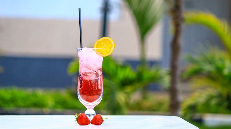 Fresh strawberry lemonade drink in tall glass